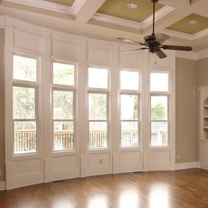 A wall of beautiful double-hung windows with white frames inside a home